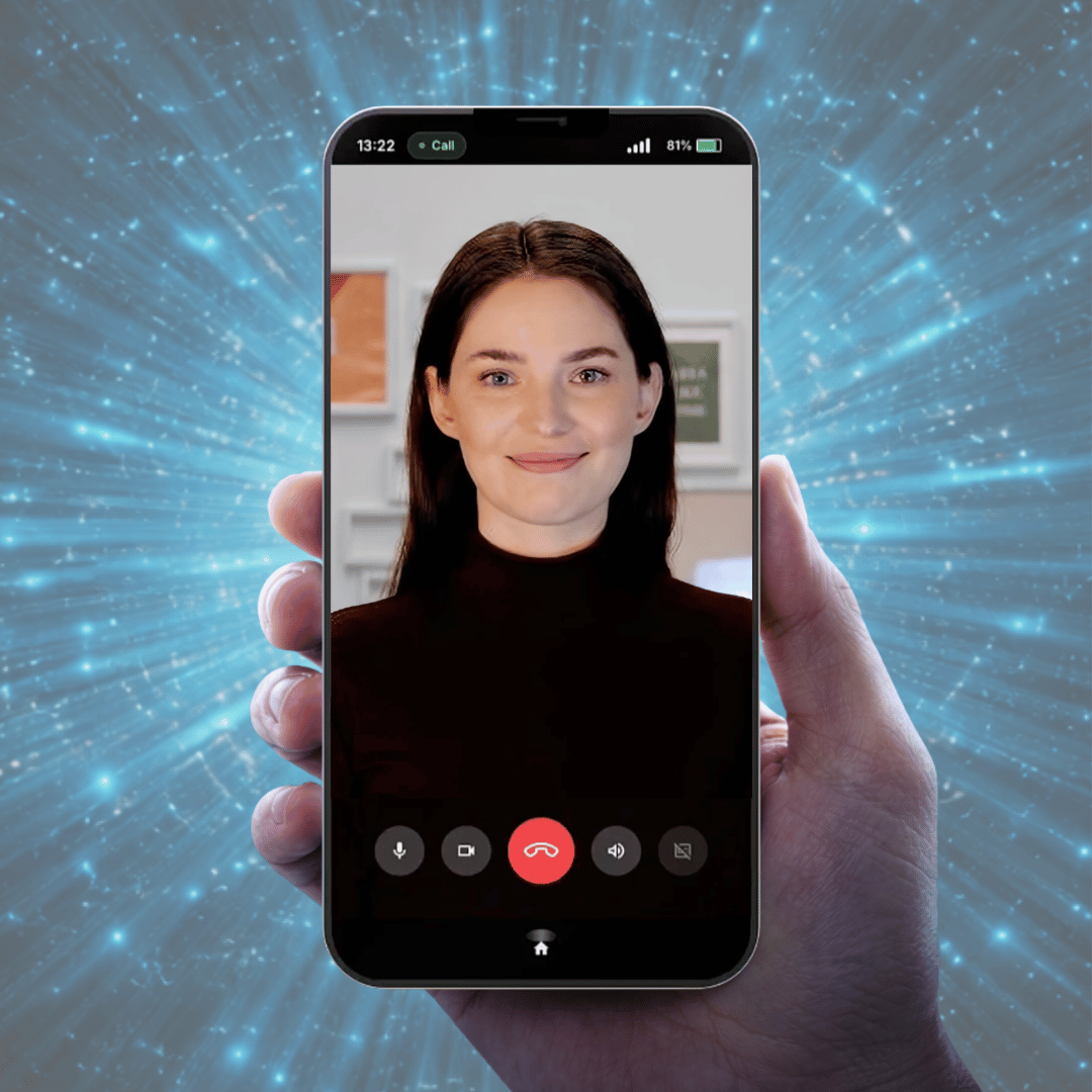 A hand holding a smartphone with an AI customer service agent called Cara smiling on the screen ready to converse.