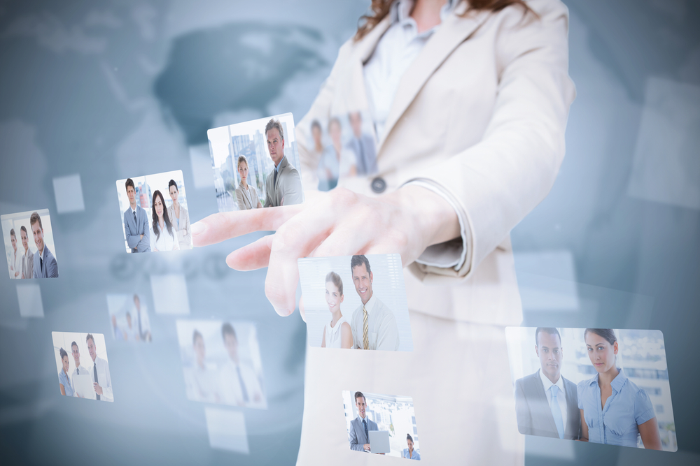 woman in suit pointing to screen