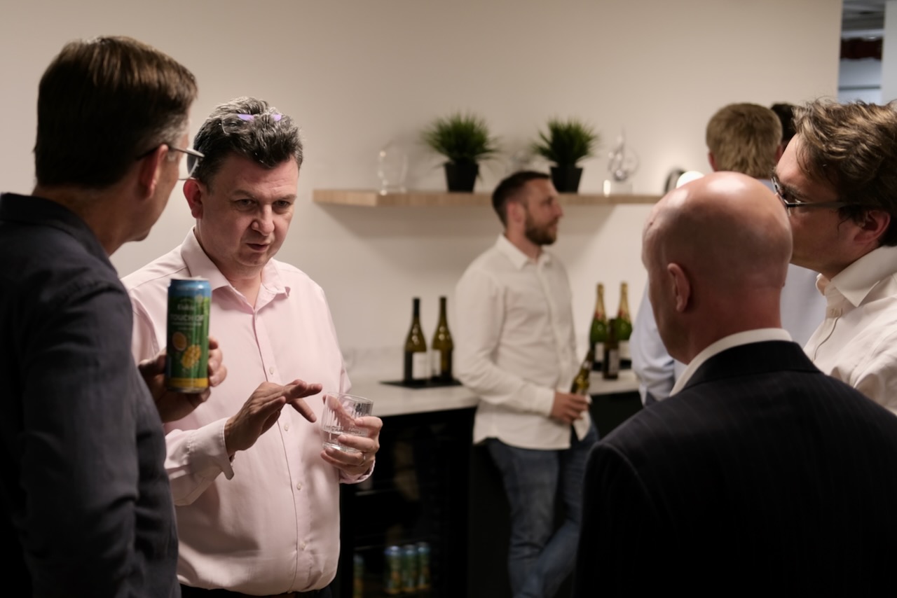 AI Expert Professor Andy Pardoe in conversation with other professionals at a business drinks event